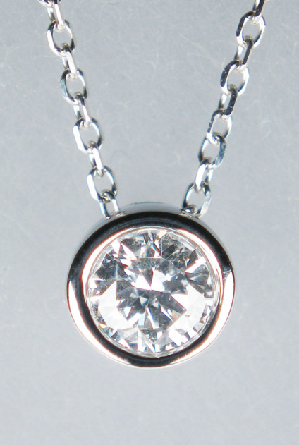0.25ct diamond pendant in 18ct white gold - Pretty 18ct white gold slider pendant with 0.25ct rubover set round brilliant cut white diamond in G colour Si clarity on a fine 16-18" 18ct white gold trace chain. Pendant is 6mm in diameter.