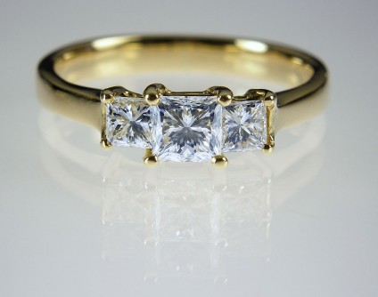 Princess cut diamond ring in 18ct yellow gold - 3 stone princess cut diamond ring. Diamonds G/VS2 clarity, total weight 0.88ct in 18ct yellow gold. Central diamond 4mm square.
