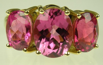 Pink Tourmaline Ring - Pink tourmaline 3 stone ring set in 18 carat yellow gold.  Central stone 8 x 10mm
