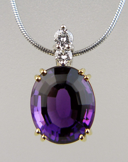 Amethyst & diamond pendant in 18ct yellow and white gold - Exquisite oval amethyst set in 18ct yellow gold with a diamond set bail in 18ct white gold and suspended from an 18ct white gold chain. Pendant is secondhand. This top quality piece has been checked by our gemmologist and jeweller and comes with a 6 months Just Gems warranty. Pendant is 19x10mm.