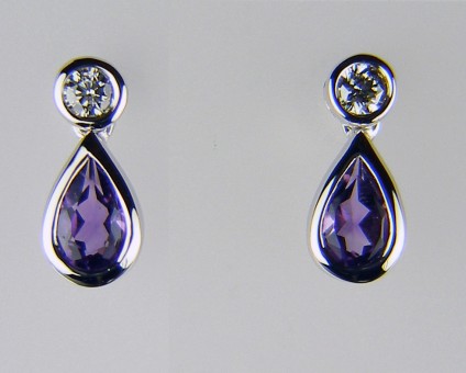 Amethyst & diamond earrings - 0.37ct pair of pear cut amethysts rubover set in 18ct white gold and suspended from a 0.08ct pair of round brilliant cut diamonds.