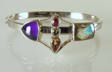 Amethyst & opal birthstone bangle - Bangle created using the birthstones of a family with three children.  Birthstones include topaz, ruby, diamond, opal and amethyst, all set in 18ct white gold.