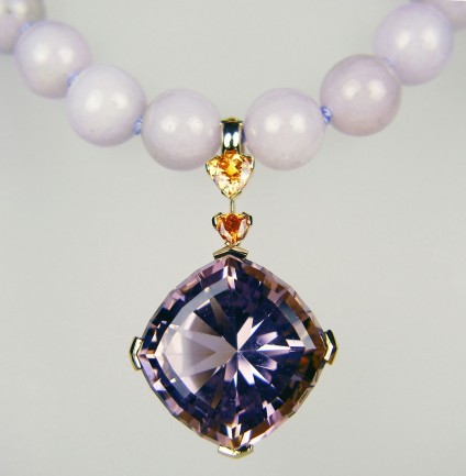 Ametrine, spessartine & lavendar jade necklace - 31.56ct ametrine, special cut by award winning lapidary, Ivan Willianson, set with 0.64ct and 0.26ct trillion cut spessartine (mandarin) garnets, mounted in 18ct yellow gold as a pearl enhancer. Worn with 10mm lavendar jadeite beads from Myanmar, hand knotted and with a gold plated silver, magnet clasp. A dramatic and unique piece, designed with skill and passion, by Helen Plumb of Just Gems.