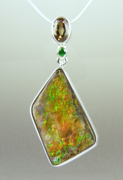 Ammolite ,andalusite & tsavorite pendant in silver - Freeform ammolite (opalised ammonite shell - fossilised) from Alberta, Canada, set with oval andalusite 0.99ct and 0.08ct round cut tsavorite garnet, in silver.