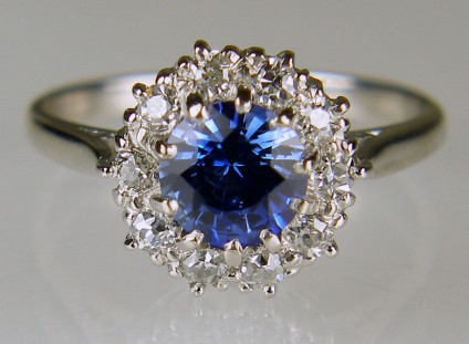 Antique style sapphire & diamond cluster ring in 18ct white gold - 1.01ct round cut sapphire in bright blue set with a halo of diamonds totalling 0.50ct and set in 18ct white gold