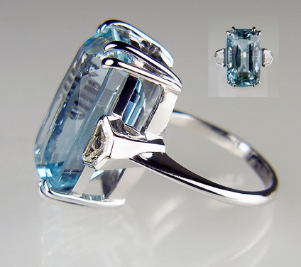 Aquamarine and diamond ring in 18ct white gold - 17.8ct rectangular cushion mixed cut aquamarine of mid blue/greenish blue colour saturation and flanked with a 0.51ct matched pair of shield cut diamonds in H colour SI clarity, mounted in an 18ct white gold ring