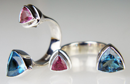 Pink tourmaline & blue topaz between finger ring in silver - Trillion cut pink tourmaline & trillion cut London Blue topaz set in silver 'between finger' ring. The silver is rhodium plated.