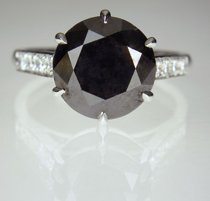 Black Diamond Ring in Platinum - Black diamond ring - Single black diamond of 6.01ct, with 0.28ct white diamonds set into the ring shoulders, in platinum.
