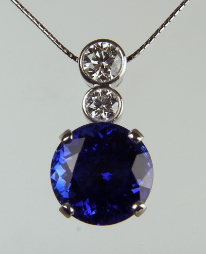Tanzanite & diamond pendant - Large round brilliant cut tanzanite of 16.8ct set with 0.52ct and 1.01ct F colour VS2 clarity diamonds with accompanying GIA reports mounted as a pendant in 18ct white gold