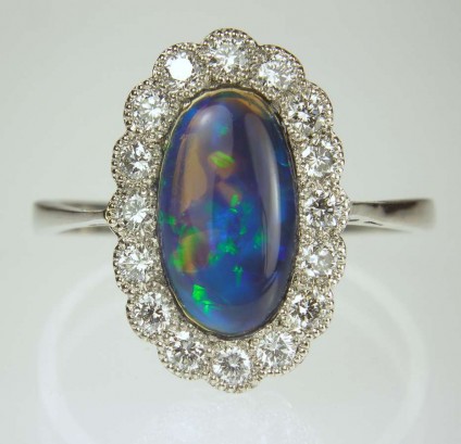 Black opal & diamond ring in platinum - Black opal and diamond cluster ring with 0.32ct f colour VS clarity diamonds.  Mounted in platinum.  Antique ring restored to nearly new condition by Just Gems.