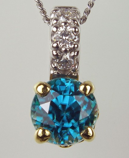 Blue Zircon & Diamond Pendant - Blue Zircon Pendant Pendant of 1.19ct blue zircon (this is a natural stone, NOT to be confused with cubic zirconia!) and 0.06ct diamond in 18 carat white & yellow gold. 5 x 11mm.
