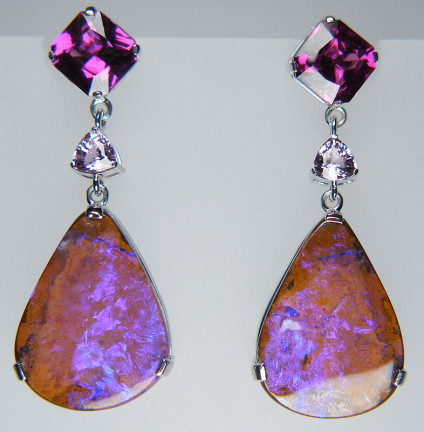 Boulder opal, rhodolite garnet & sapphire earringsn in 18ct white gold - Drop shaped pair of vibrant purple boulder opals weighing 14.68ct set with a 2.97ct pair of purple garnets (rhodolite) from Tanzania, and a dainty 0.61ct pair of trillion cut lilac sapphires, all mounted as earrings in 18ct white gold. The earrings are 35mm long and 14mm wide. Unique, spectacular, vividly purple.