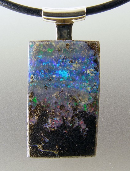 Boulder opal pendant in silver - Boulder opal pendant in silver on leather cable. 37 x 17mm.