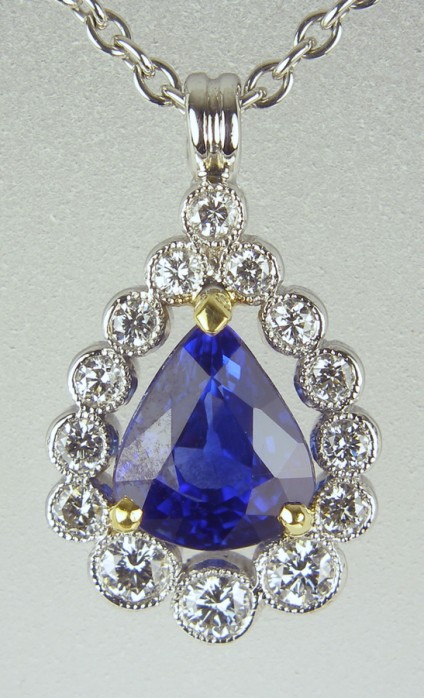 Sapphire & diamond pendant - Pear cut sapphire 0.97ct set with 0.18ct white diamonds in 18ct white & yellow gold.
