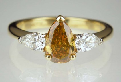 Golden pear cut diamond ring - Golden brown pear cut 1.12ct diamond with Gem-A cert, set with a matched pair of 0.46ct pear cut diamonds in G colour VS clarity, set in 18ct white & yellow gold. The centre diamond in this ring is strongly yellow/green fluorescent and this gives the stone a fabulous colour range that changes with illumination intensity and whether the stone is viewed under artificial or natural light. Just STUNNING!