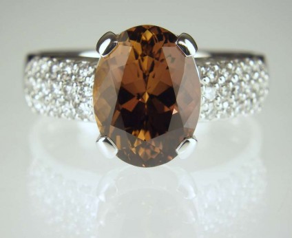 Brown sapphire & diamond ring - 4.56ct oval brown sapphire set with 0.47ct round brilliant cut diamonds in 18ct white gold