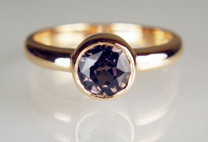 Brownish grey sapphire ring in 18ct rose gold - 1.34ct round brownish greyish sapphire in 18ct rose gold rubover ring. The sapphire is 6.1mm in diameter.