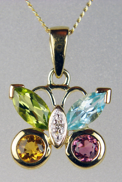Multigem butterfly pendant in 9ct gold - Dainty butterfly pendant set with peridot, tourmaline, citrine, blue topaz, & diamond in 9ct yellow gold and suspended from a delicate 18" chain