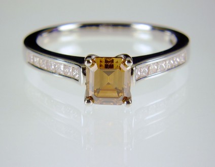Coloured & white diamond ring in platinum - Cinnamon diamond ring in platinum.  Natural golden brown diamond, emerald cut, 5mm square set in platinum with princess cut diamond shoulders totalling 0.3ct.
