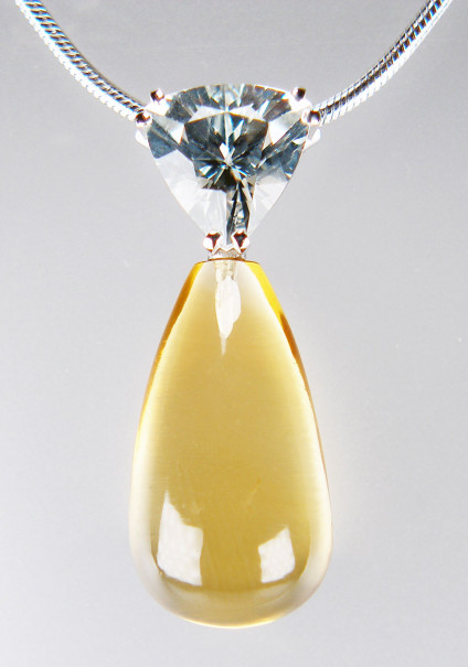 Citrine & goshenite pendant in 9ct white gold - 10/18mm polished drop shaped citrine suspended from a 1.40ct trillion cut goshenite (colourless beryl), on an 18" snake chain, all in 9ct white gold. The pendant is 27mm long. This pendant and chain is included in our 20th anniversary 50% sale and now costs £295.