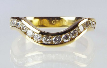 Curved Eternity Ring - 14 round brilliant cut 0.56ct diamonds set in a curved eternity ring in yellow gold