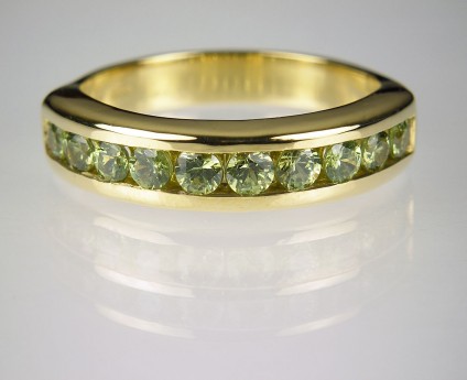 Demantoid garnet ring in gold - 1.01ct Namibian demantoid garnet ring channel set in 18ct yellow gold.
