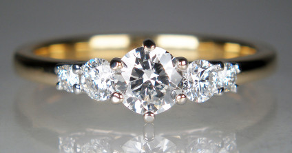 0.68ct five stone diamond ring in 18ct yellow gold - 0.68ct of round brilliant cut diamonds in F colour VS clarity, claw set in 18ct white gold and mounted on an 18ct yellow gold shank. Ring is wedfit (it will sit snuglu against a diamond set or plain wedding band) and size N.