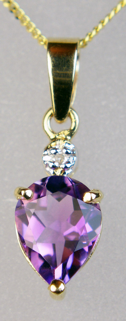 Amethyst & diamond pendant - Delicate pendant in 9ct yellow gold set with a pear cut amethyst and dainty 1.1mm diamond, on an 18" chain. Pendant in 18mm long and 6mm wide.