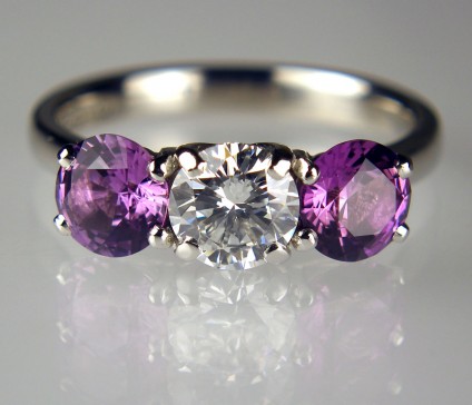 Purple sapphire & diamond ring - 0.81ct round brilliant cut diamond in F colour SI2 clarity, excellent cut quality, set with a matched pair of 1.74ct purple sapphires, mounted in platinum