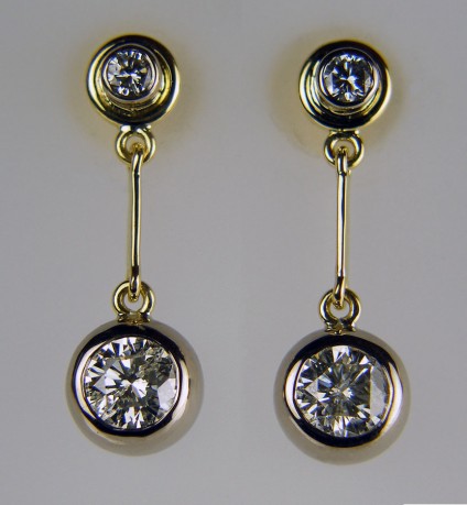 Diamond drop earrings - Diamond earrings made using the customer's two pairs of claw set diamond earstuds, totally remodelled into a stunning pair of diamond drop earrings using a combination of rubover settings in 18ct white & yellow gold