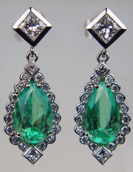 Emerald & diamond earrings - Emerald & diamond earrings in platinum set with a 4.22ct pair of pear cut Colombian emeralds and 1.35ct diamonds in F/VS quality. Largest diamond are a pair of 0.33ct princess cuts. Total earring length 29mm.