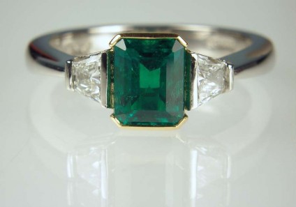 Emerald & diamond ring - 1.03ct emerald (from Muzo, Colombia), set with 0.31ct pair of taper cut diamonds F colour VVS clarity in platinum and 22ct yellow gold 
