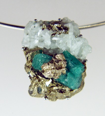 Rough emerald pendant in palladium - Colombian emerald mineral specimen, rough and unpolished, set in simple palladium claw mount and suspended from stainless steel cable