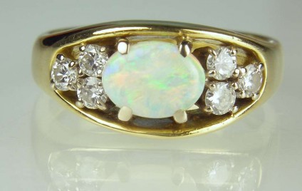 Opal & diamond ring - Estate piece.  Set with 0.5ct oval white opal and 0.24ct diamonds in 18ct yellow gold.