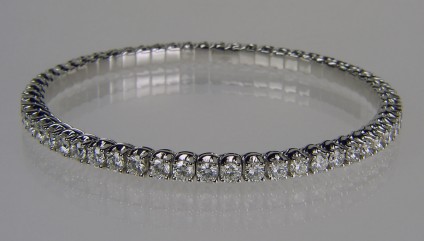 Expanding range full set diamond bangle - Picchiotti designed and manufactured expanding full set bangle with 5.61ct of G colour VS clarity round brilliant cut diamonds, each diamond 3mm in diameter. The bangle is made with the diamonds mounted in jointed links connected to a superbly crafted highly durable titanium spring. The bangle can expand up to 4cm to allow comfortable and secure wear.  It is flexible and comfortable to wear, resistant to knocks and pressure, making it a secure and extremely durable alternative to the traditional diamond tennis bracelet or rigid bangle.

18ct white gold. 

Bangle is manufactured to order only and can be made with any combination of gemstones to the customer's requirements.

