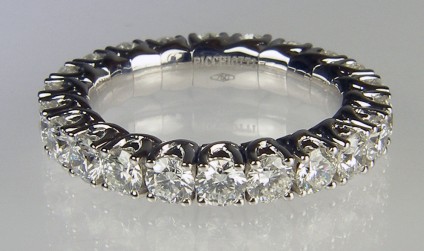 Expanding range diamond eternity ting - Picchiotti designed and manufactured expanding full set eternity ring with 2.33ct of G colour VS clarity round brilliant cut diamonds, each diamond 3mm in diameter. The ring is made with the diamonds mounted in jointed links connected to a superbly crafted highly durable titanium spring. The ring can expand up to 5 ring sizes to allow comfortable and secure wear even on fingers with large knuckles or where the wearer routinely experiences changes in finger size. 18ct white gold. 

Ring is manufactured to order only and can be made with any combination of gemstones to the customer's requirements.


