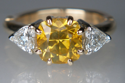 Yellow sapphire & diamond ring in platinum & 18ct yellow gold - Lady’s dress ring set with a central 2.39ct square cushion cut natural yellow sapphire claw set in 18ct yellow gold and flanked by a 0.49ct matched pair of heart cut diamonds in F colour VS clarity, claw set in platinum.
The ring shank is a 2mm J series expanding shank in 14ct yellow gold size L, manufactured by Fingermate.
