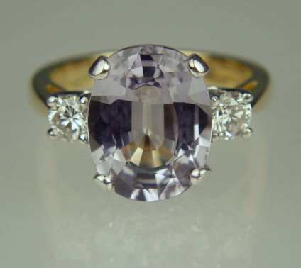Grey sapphire & diamond ring - 4.90ct oval cut grey sapphire set with 0.30ct diamonds in 18ct yellow gold and platinum