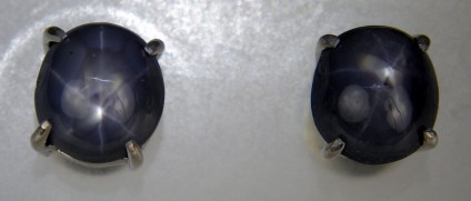 Grey star sapphire cabochon earstuds  - Unusual grey star sapphire cabochon pair weighing 4.92ct set as earstuds in rhodium plated silver.  The star sapphires are from Myanmar.