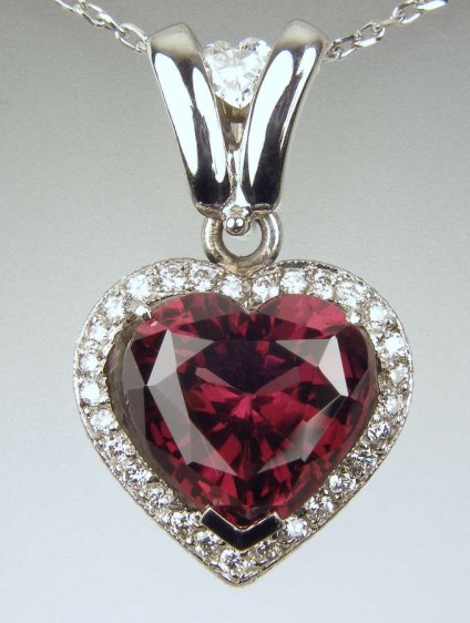 Red tourmaline & diamond pendant - 4.25ct heart cut red tourmaline set with 0.3ct of round and heart cut diamonds, mounted in 18ct white gold. The pendant is 23mm long and 14mm wide. 