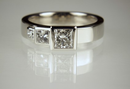Princess cut diamond ring - 1/2ct diamond with 20pt & 5pt diamonds, all princess cut, and bezel set in platinum