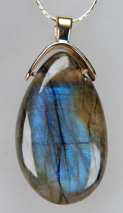 Labradorite polished drop pendant in yellow gold - Fabulous adularescent greens and golds on one side, blues, greys and golds on the other side, polished bead of labradorite in a yellow gold pendant. The pendant measures 40 x 20mm. Price excluded chain.