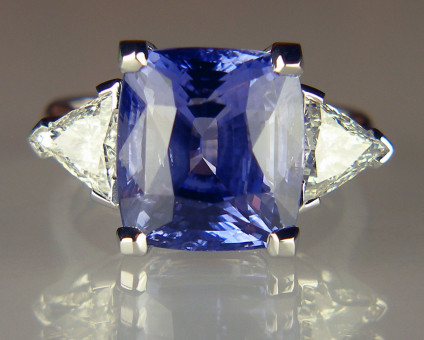 Sapphire & triangular diamond ring in 18ct white gold - 11.47ct cushion cut Sri Lankan sapphire set with a 1.13ct matched pair of triangular diamonds G colour VS1 & SI1 clarity each stone respectively, mounted in 18ct white gold ring