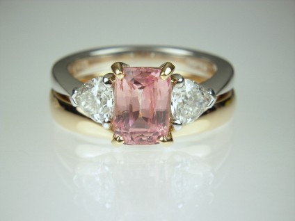 Padparadscha & Diamond Ring - Unheated, natural colour, beautiful Padparadscha pink 2.6ct sapphire mounted with a matched pair of heart shaped white diamonds 0.92ct, E-F colour VS clarity, in 18ct rose and white gold. With a shaped rose gold wedding band.