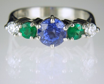 Sapphire, emerald & diamond ring in platinum - Platinum ring set with 1.5ct mid blue Sri Llankan sapphire, a pair of fine quality Colombian emeralds totalling 0.3ct and a pair of E colour VS clarity diamonds totalling 0.2ct