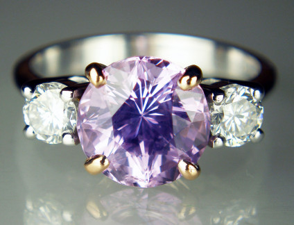 Lilac sapphire ring in 18ct white gold - Spectacular brilliant cut lilac sapphire of 3.61ct flanked by a 0.56ct matched pair of 4.1mm round brilliant cut diamonds of H colour VS clarity. The sapphire is mounted in 18ct rose gold, the diamonds and shank are in 18ct white gold