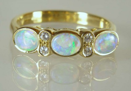 Opal & diamond ring - 0.62ct of pretty white opals with vivid blue/green colour flashes set with 0.09ct white diamonds (G/VS) in 18ct yellow gold