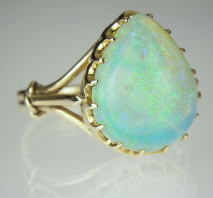 Opal cabochon ring - Estate piece set with large pear shaped cabochon opal in vivid turquoise blues, mounted in 9ct yellow gold