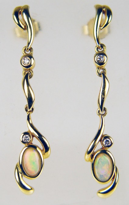 opal & diamond earrings in 18ct yellow gold - Delicate drop earrings with oval white solid opals set with 4 x 1.5mm diamonds mounted in 18ct yellow gold. Earrings are 35mm long.