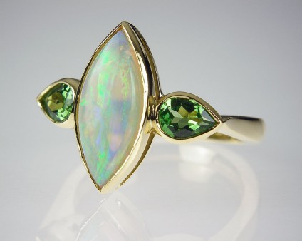 Opal & tsavorite garnet ring in gold - Opal & green garnet ring - Ring set with 1.33ct light opal and a pair of pear cut tsavorite garnets in 18ct yellow gold.
